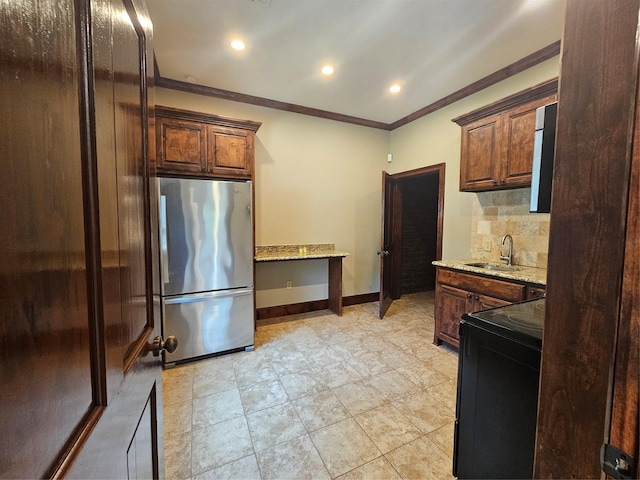 10111 Bluffview Cir, Pilot Point, TX 76258 - kitchen with freestanding refrigerator, black / electric stove, crown molding, light stone countertops, and backsplash