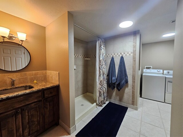10111 Bluffview Cir, Pilot Point, TX 76258 - bathroom featuring washer and dryer, vanity, a tile shower, and tile patterned floors