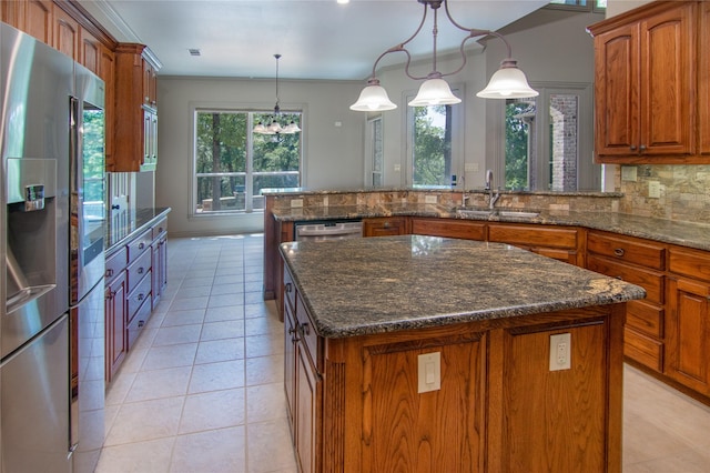 10111 Bluffview Cir, Pilot Point, TX 76258 - kitchen with appliances with stainless steel finishes, a peninsula, brown cabinets, light tile patterned flooring, and crown molding