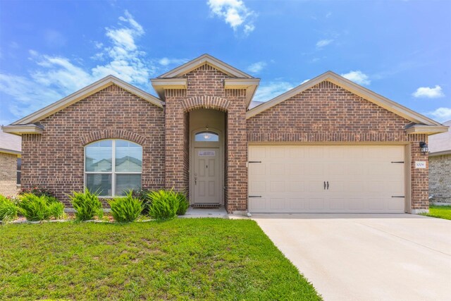 3008 Skinner Dr, Waco, TX 76655 - view of front of home with brick siding, an attached garage, driveway, and a front yard