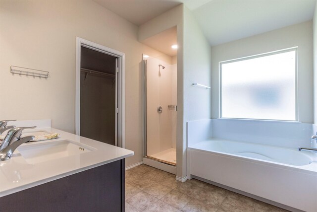 3008 Skinner Dr, Waco, TX 76655 - bathroom featuring a garden tub, a stall shower, vanity, and a walk in closet