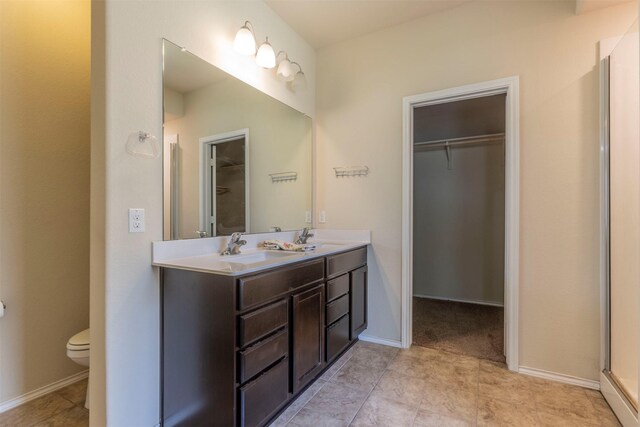 3008 Skinner Dr, Waco, TX 76655 - bathroom featuring double vanity and a walk in closet