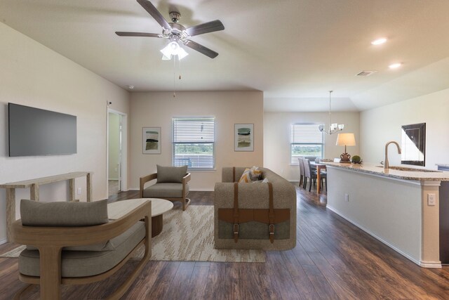 3008 Skinner Dr, Waco, TX 76655 - living room featuring dark wood-style floors, a ceiling fan, and a chandelier