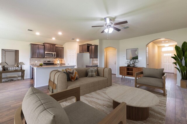 3008 Skinner Dr, Waco, TX 76655 - living room featuring arched walkways, wood finished floors, ceiling fan, and recessed lighting