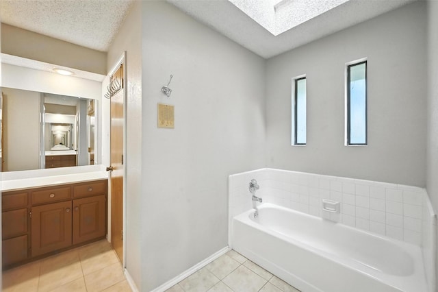 4603 Michelle Dr, Arlington, TX 76016 - bathroom featuring tile patterned flooring, vanity, a bath, a textured ceiling, and a skylight
