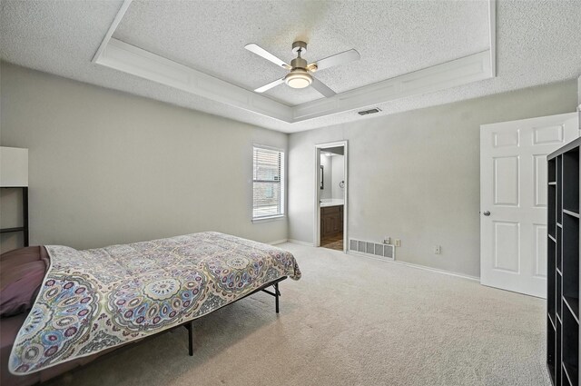 4603 Michelle Dr, Arlington, TX 76016 - bedroom with a raised ceiling, a textured ceiling, carpet, ceiling fan, and ensuite bathroom