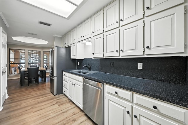4603 Michelle Dr, Arlington, TX 76016 - kitchen featuring stainless steel dishwasher, light wood-style floors, and white cabinetry