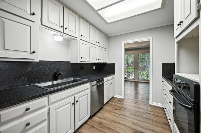 4603 Michelle Dr, Arlington, TX 76016 - kitchen with stainless steel dishwasher, black oven, light wood finished floors, white cabinetry, and dark countertops