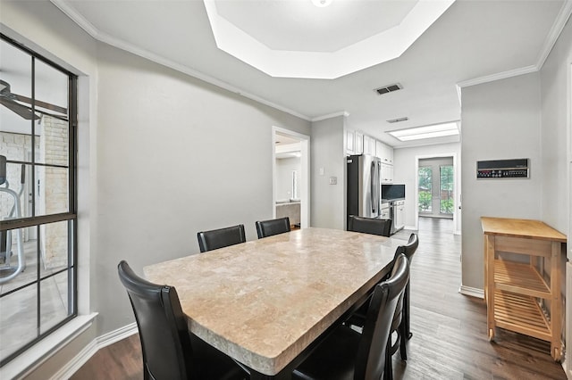 4603 Michelle Dr, Arlington, TX 76016 - dining space with dark wood-style flooring, crown molding, and a raised ceiling