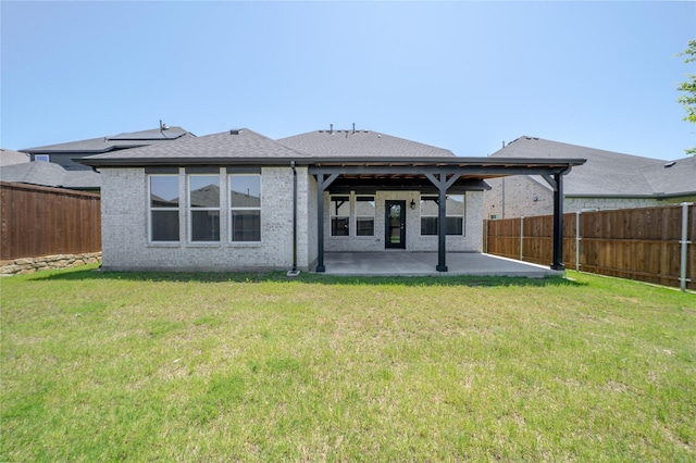 204 Savannah Ln, Oak Point, TX 75068 - back of property featuring a patio area, a fenced backyard, brick siding, and a shingled roof
