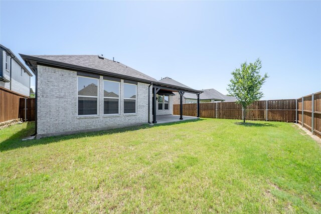204 Savannah Ln, Oak Point, TX 75068 - rear view of house with brick siding, a fenced backyard, and a patio