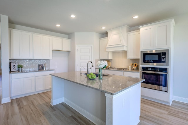 204 Savannah Ln, Oak Point, TX 75068 - kitchen with stainless steel appliances, light wood-style flooring, light stone counters, backsplash, and recessed lighting