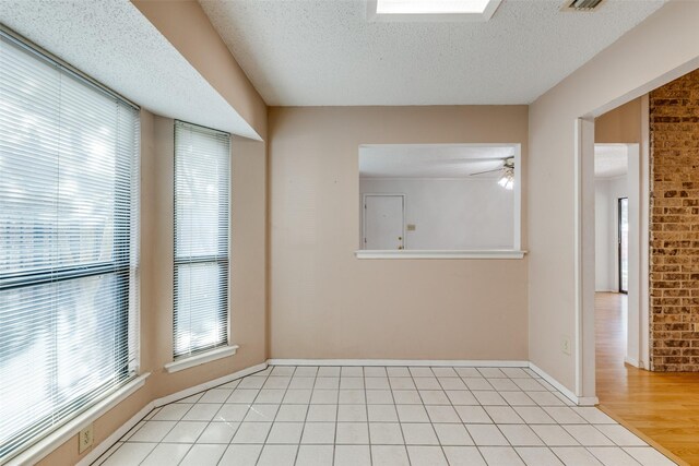 1608 Stroud Ln, Mesquite, TX 75150 - empty room featuring ceiling fan, a textured ceiling, and light tile patterned floors