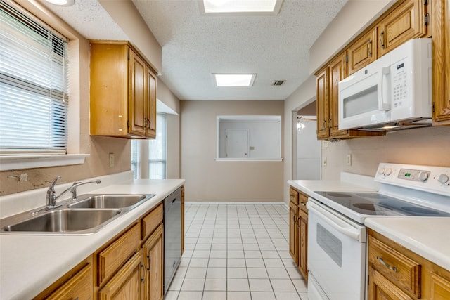1608 Stroud Ln, Mesquite, TX 75150 - kitchen with white appliances, light countertops, light tile patterned floors, plenty of natural light, and a textured ceiling