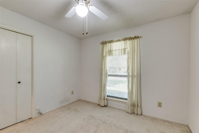 1608 Stroud Ln, Mesquite, TX 75150 - unfurnished bedroom featuring carpet, a closet, a textured ceiling, and a ceiling fan