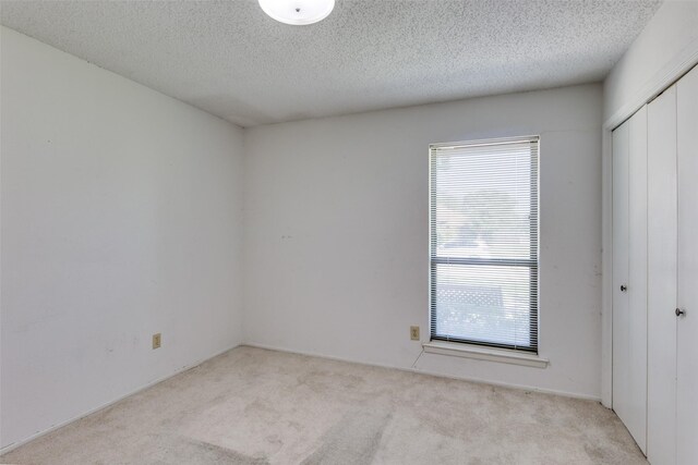1608 Stroud Ln, Mesquite, TX 75150 - spare room featuring healthy amount of natural light, carpet flooring, and a textured ceiling