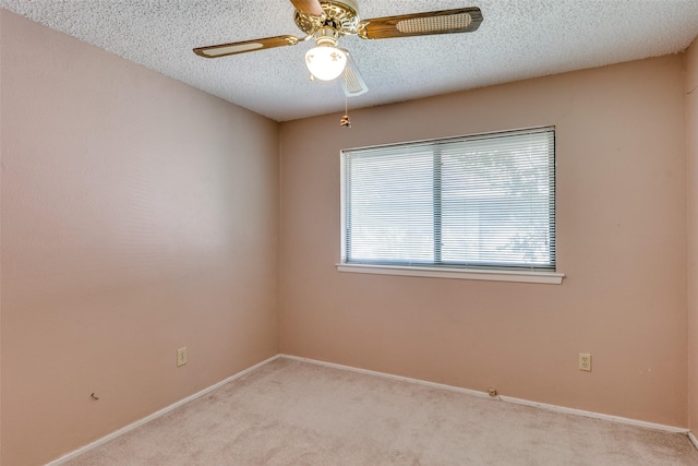 1608 Stroud Ln, Mesquite, TX 75150 - spare room with light colored carpet, a textured ceiling, and ceiling fan