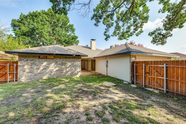 1608 Stroud Ln, Mesquite, TX 75150 - rear view of property with a gate, a chimney, and a shingled roof