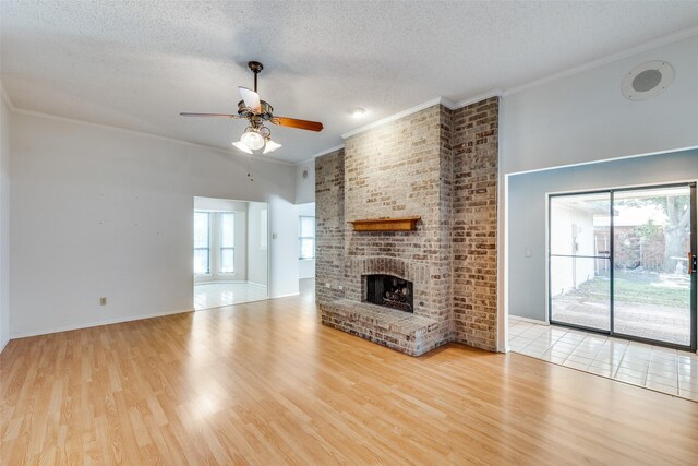 1608 Stroud Ln, Mesquite, TX 75150 - unfurnished living room featuring ceiling fan, healthy amount of natural light, a textured ceiling, wood finished floors, and ornamental molding