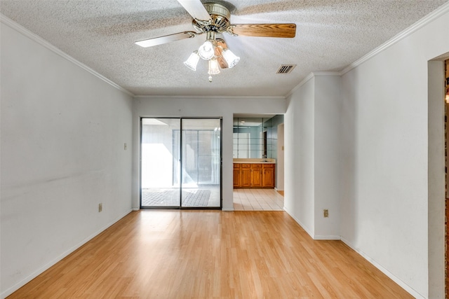 1608 Stroud Ln, Mesquite, TX 75150 - unfurnished room with a textured ceiling, light wood-style floors, a ceiling fan, and crown molding