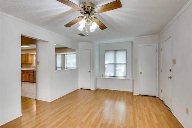 1608 Stroud Ln, Mesquite, TX 75150 - empty room with light wood-style flooring, a textured ceiling, crown molding, and a ceiling fan