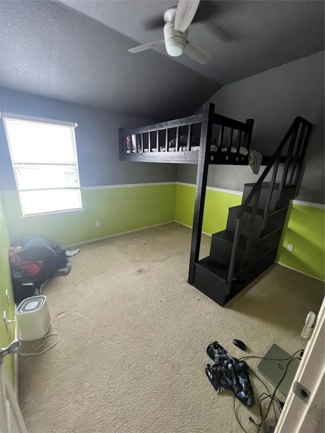 5901 Westgate Dr, Fort Worth, TX 76179 - unfurnished bedroom with carpet floors, vaulted ceiling, a ceiling fan, and a textured ceiling