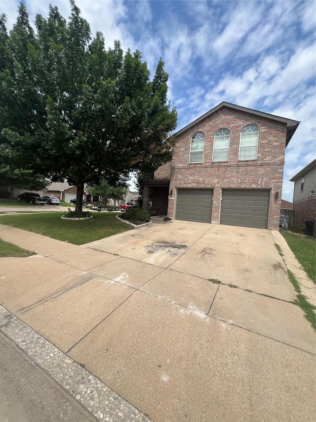 5901 Westgate Dr, Fort Worth, TX 76179 - view of front of property featuring a garage, concrete driveway, brick siding, and a front lawn