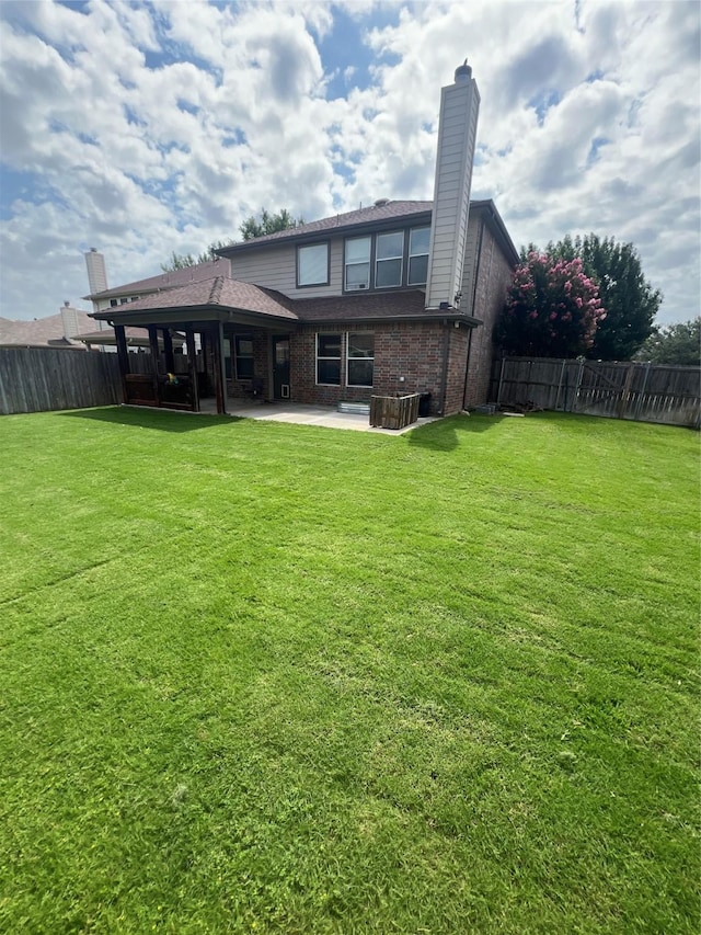 5901 Westgate Dr, Fort Worth, TX 76179 - rear view of house with a patio, a chimney, and brick siding
