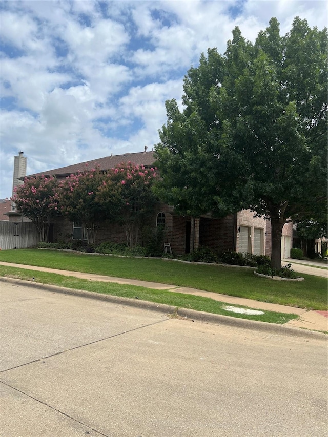 5901 Westgate Dr, Fort Worth, TX 76179 - view of property hidden behind natural elements with brick siding