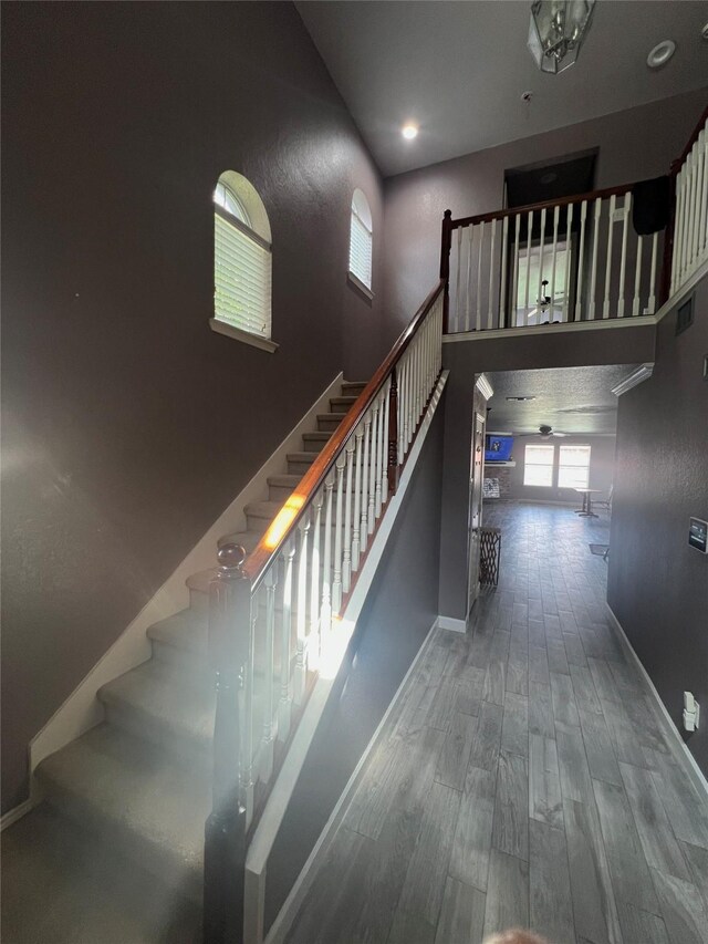 5901 Westgate Dr, Fort Worth, TX 76179 - stairway with wood finished floors and a towering ceiling