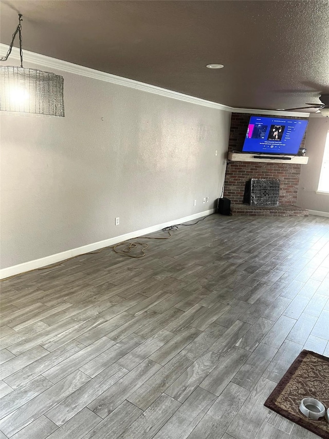 5901 Westgate Dr, Fort Worth, TX 76179 - unfurnished living room featuring wood finished floors, a brick fireplace, and crown molding