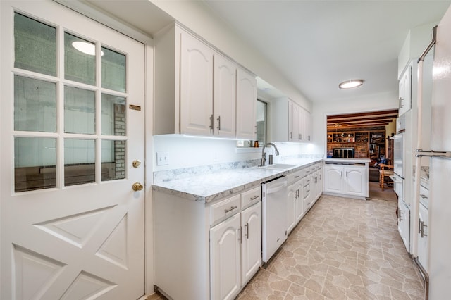 3256 Lancelot Dr, Dallas, TX 75229 - kitchen featuring white appliances, white cabinets, light stone finish flooring, and light stone countertops