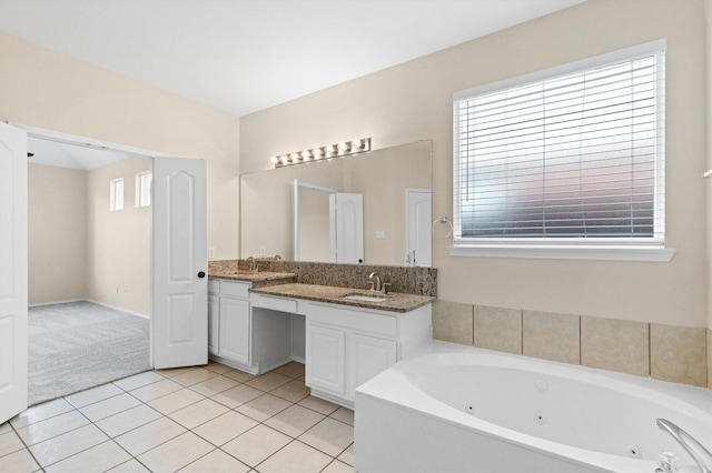 8516 Ontario Dr, Mckinney, TX 75072 - bathroom featuring double vanity, a whirlpool tub, tile patterned flooring, and plenty of natural light