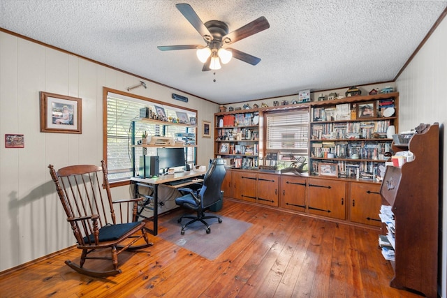 120 Woodland Ave, Corsicana, TX 75110 - home office with crown molding, a textured ceiling, a ceiling fan, and hardwood / wood-style floors