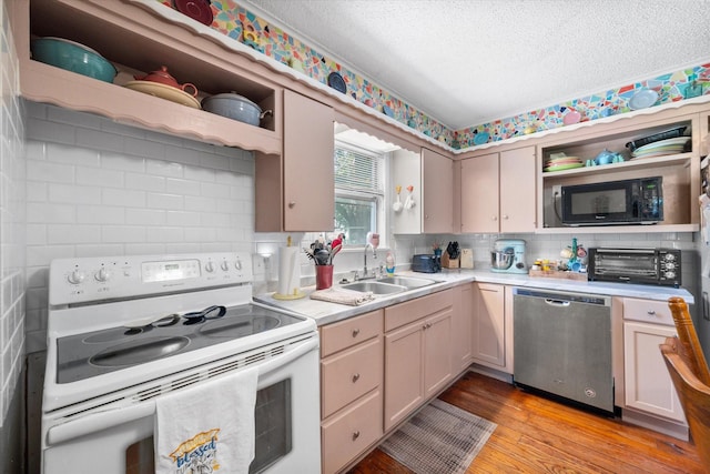 120 Woodland Ave, Corsicana, TX 75110 - kitchen with white electric range oven, dishwasher, open shelves, black microwave, and light countertops