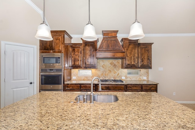 4600 Evenstar Way, Plano, TX 75074 - kitchen with custom range hood, stainless steel appliances, tasteful backsplash, light stone countertops, and crown molding