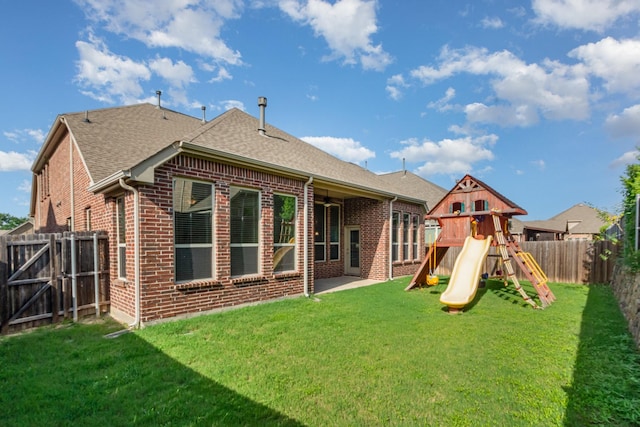 4600 Evenstar Way, Plano, TX 75074 - back of house with brick siding, a fenced backyard, a playground, roof with shingles, and a gate