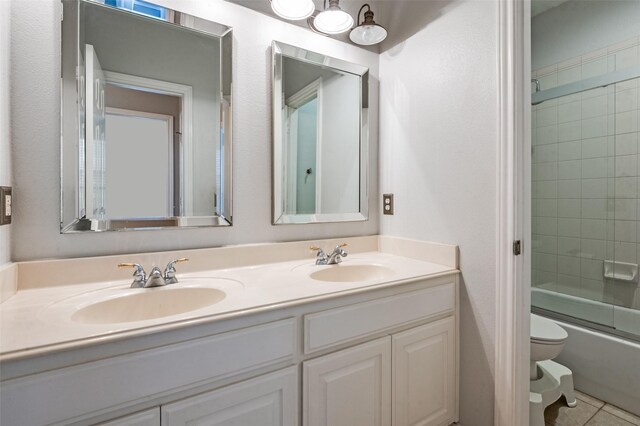 2400 Silverstone Ln, Mckinney, TX 75072 - bathroom with double vanity, bath / shower combo with glass door, and tile patterned floors