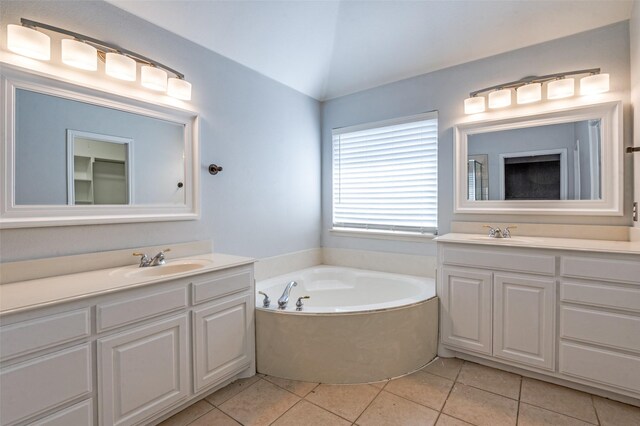 2400 Silverstone Ln, Mckinney, TX 75072 - full bath featuring two vanities, tile patterned flooring, a bath, and vaulted ceiling