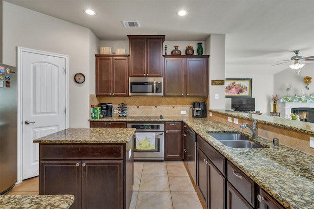 520 Rustic Oak Ln, Mckinney, TX 75072 - kitchen with stainless steel appliances, backsplash, ceiling fan, light stone countertops, and recessed lighting