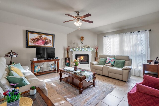 520 Rustic Oak Ln, Mckinney, TX 75072 - living area with light tile patterned floors, ceiling fan, a warm lit fireplace, and lofted ceiling