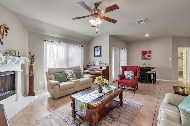 520 Rustic Oak Ln, Mckinney, TX 75072 - living room featuring light tile patterned flooring, a ceiling fan, and a lit fireplace