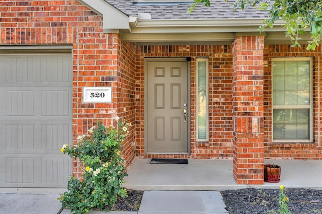 520 Rustic Oak Ln, Mckinney, TX 75072 - property entrance featuring brick siding, a shingled roof, and a garage