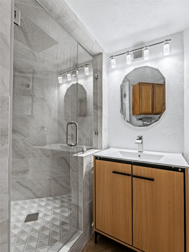3101 Townbluff Dr Unit 922, Plano, TX 75075 - full bathroom featuring vanity, a stall shower, and a textured ceiling