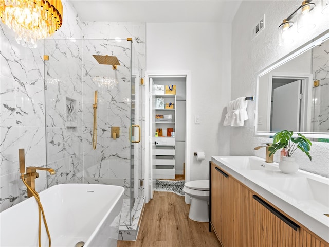 3101 Townbluff Dr Unit 922, Plano, TX 75075 - full bathroom featuring a freestanding bath, a marble finish shower, wood finished floors, vanity, and a chandelier