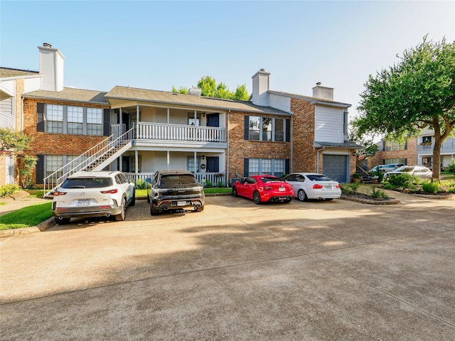 3101 Townbluff Dr Unit 922, Plano, TX 75075 - view of front facade with a chimney, an attached garage, driveway, and brick siding