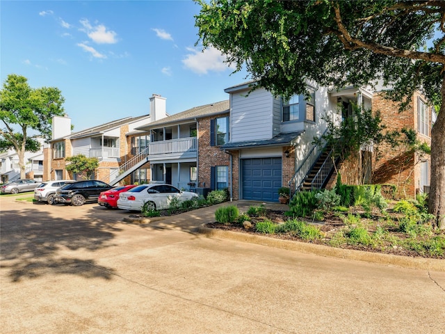 3101 Townbluff Dr Unit 922, Plano, TX 75075 - view of building exterior with stairs, a residential view, and a garage