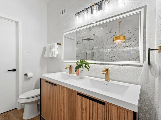 3101 Townbluff Dr Unit 922, Plano, TX 75075 - full bath with a textured wall, a marble finish shower, double vanity, and wood finished floors