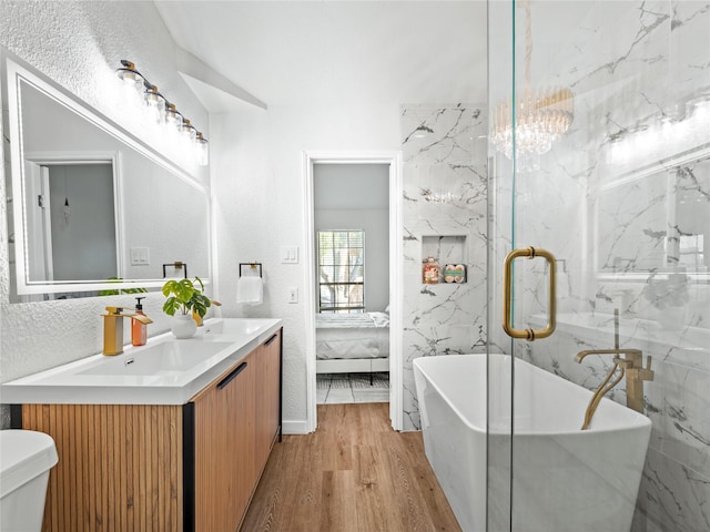 3101 Townbluff Dr Unit 922, Plano, TX 75075 - ensuite bathroom with wood finished floors, a freestanding tub, double vanity, and a marble finish shower