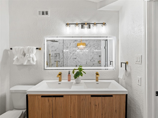 3101 Townbluff Dr Unit 922, Plano, TX 75075 - bathroom with double vanity, a textured wall, and a marble finish shower